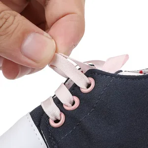 Detailed view showing the soft pink ribbon laces on navy blue canvas infant pre-walker shoes