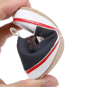 Detail view showing the flexible soft sole of navy blue infant pre-walker baby shoes