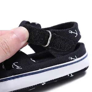 Close-up of adjustable velcro strap on navy blue baby anchor sandals