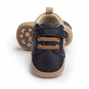 Navy blue baby pre-walker shoes with tan non-slip soles for 0-12 months infants