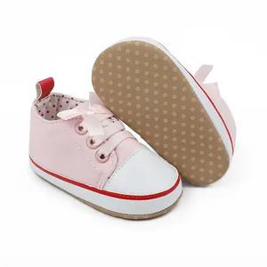 Detail showing pink baby girl walking shoes with white toe cap and anti-slip sole