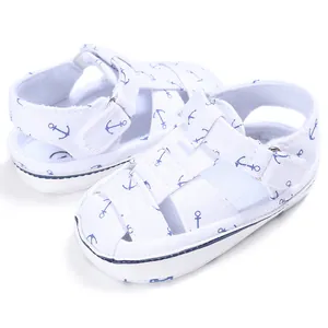 White baby walker sandals with blue anchor print and velcro straps