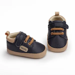 Detail view of navy blue baby walking shoes with tan accents and soft sole
