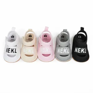Detailed macro view of infant summer pre-walker sandals in five vibrant colors with NEKL print