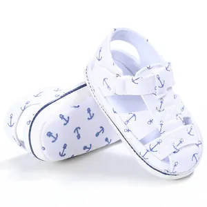 Detail view of white baby walking sandals with cute blue anchor patterns for kids