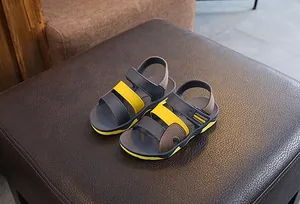 Detailed view of stylish boys summer beach sandals in grey and yellow with velcro straps