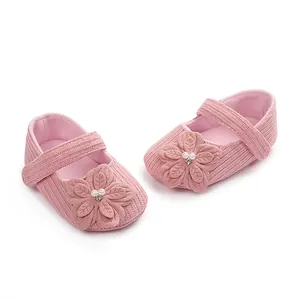Vista dettagliata delle scarpe da principessa rosa per neonata con fiori e decorazioni in perle