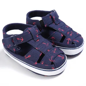 Navy blue baby walking sandals with red anchor print and adjustable velcro straps