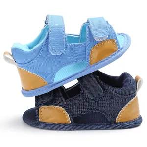 Side view of denim baby sandals with Velcro straps and leather accents