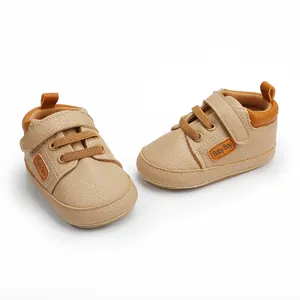 Detailed macro view of beige faux leather baby walking shoes with velcro straps.