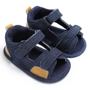 Close-up of navy blue denim baby sandals featuring adjustable velcro strap details.