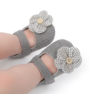 Detailed close-up of grey indoor soft sole baby walking shoes with plaid flower decoration