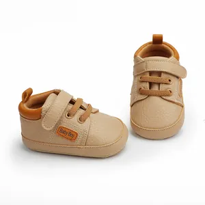 Detailed macro view of beige infant walking shoes with practical hook and loop strap