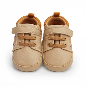 Detailed front view of soft beige infant walker shoes with secure velcro straps and elastic laces