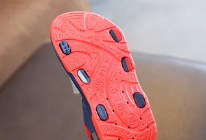Detailed view of the durable red non-slip rubber outsole on boys' summer sandals.