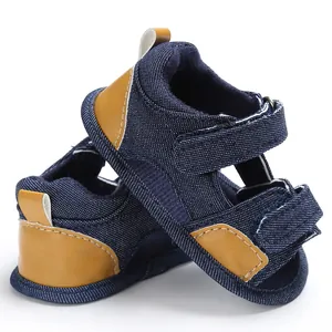 Close-up of baby denim sandals with velcro straps and leather accents
