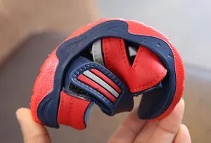 Detailed view of the flexible and soft sole on red and navy blue boys' summer beach sandals