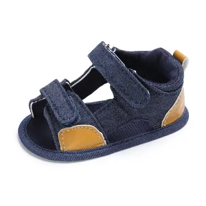 Close-up of blue denim baby sandal with velcro straps and brown leather accents