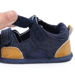 Detailed macro view of baby denim sandals with adjustable velcro strap closure