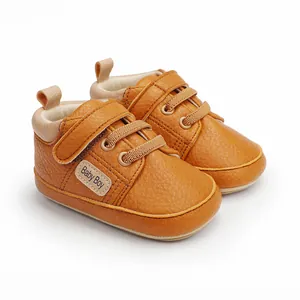 Detailed view of brown baby walking shoes with Baby Boy label and Velcro strap