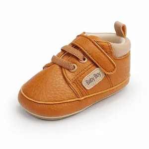 Detail view of brown faux leather baby walking shoe with hook and loop strap