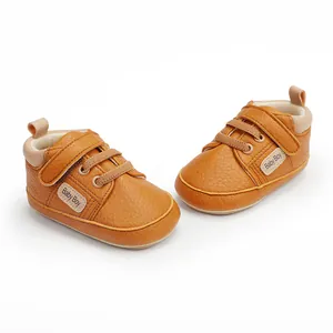 Detailed view of brown faux leather baby pre-walker shoes with Velcro strap and laces