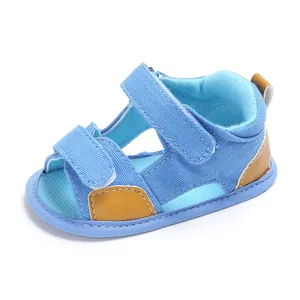 Light blue denim baby sandals with velcro straps and brown leather accents