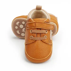 Detailed close-up of brown faux leather baby pre-walker shoes for 0-12 months infants