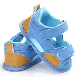Detailed view of blue denim baby sandals with convenient velcro straps for infants