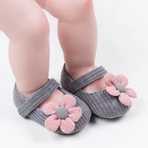 Close-up of gray knit baby princess walking shoes featuring cute pink floral decoration
