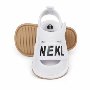 White baby sandals with NEKL text print and soft anti-slip rubber sole for summer toddlers