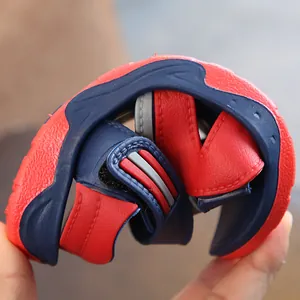 Flexible soft-soled red and blue boys' summer beach sandals shown being folded for comfort