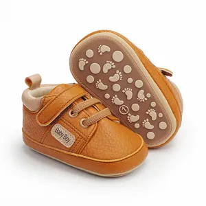 Detailed view of brown faux leather baby walker shoes with anti-slip footprint sole