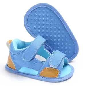 Close-up of blue denim baby sandals with hook and loop straps and non-slip sole