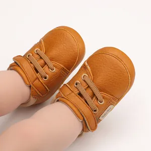Close-up detail showing the soft brown textured leather of these infant baby walking shoes