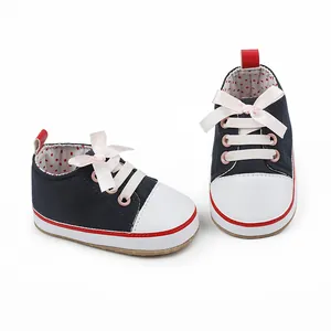 Detailed view of navy baby soft sole pre-walker shoes with elegant pink ribbon laces