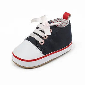 Detailed view of navy blue baby girl walking shoe with pink silk bow and polka dot lining