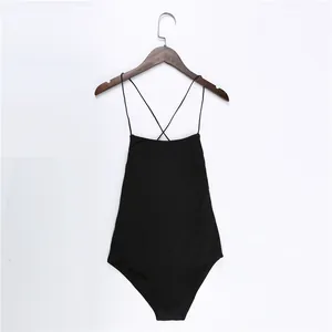 Detail view of a black sexy backless bodysuit with thin spaghetti straps on hanger