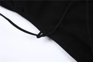 Close-up detail of adjustable straps and stitching on a black backless sexy bodysuit.