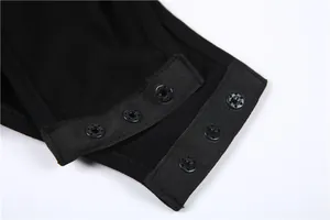 Detailed macro shot of the functional triple snap button closure on black summer bodysuit