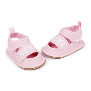 Detailed view of pink breathable canvas baby sandals with Velcro strap for summer