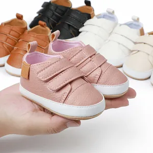 Close-up detail of soft faux leather baby walking shoes with double velcro straps
