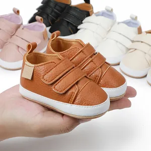 Close-up of brown faux leather baby sneakers for infants with double hook-and-loop straps
