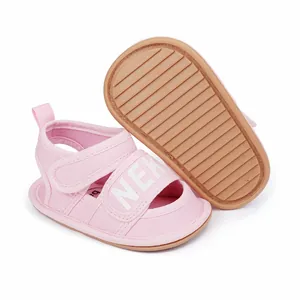 Detail view of pink infant walker sandals featuring anti-slip textured rubber sole and strap