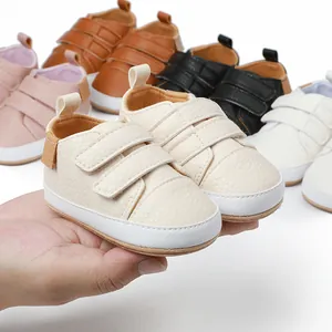 Close-up of cream soft-sole baby walking shoes with multi-color options background