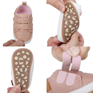 Detail of pink baby walker shoe showing soft anti-slip sole and velcro straps.