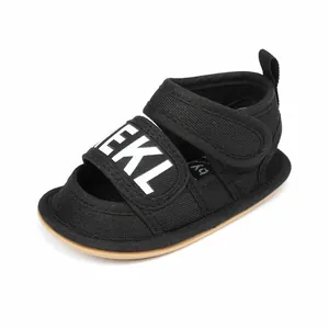Detailed view of black canvas baby sandals with soft sole and white BEKL lettering