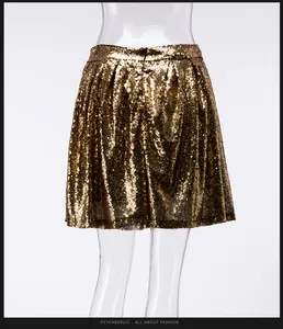 Close-up back view detail of a sparkling gold sequin pleated mini skirt on mannequin.