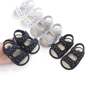 Close-up of baby summer sandals in various colors with soft soles and velcro straps