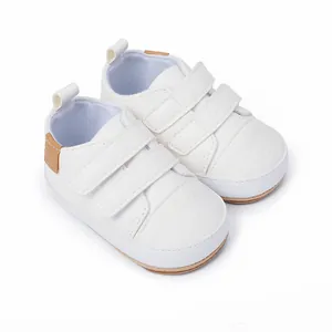 Detailed view of white baby boy pre-walker sports shoes featuring double velcro straps